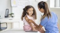 small kid getting a vaccine at the doctors office